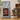 Kitten eating from a bowl next to a bag of Content Kitten food on a wooden surface.